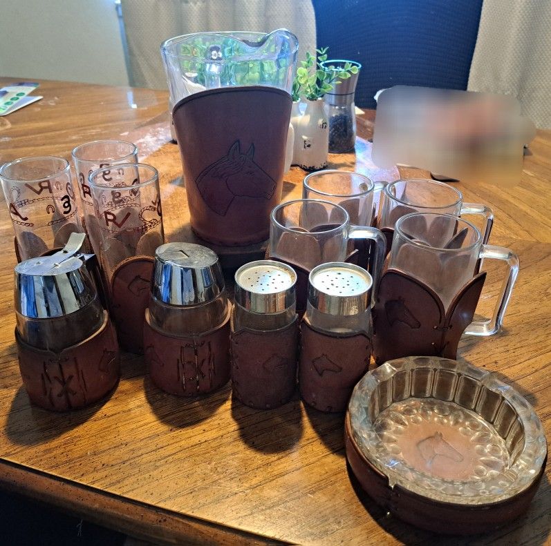 This is a charming vintage glassware and barware set featuring a Western ranch theme.