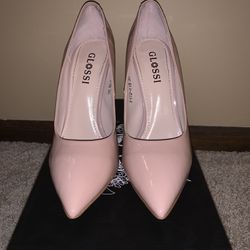 Nude Patent leather pumps.