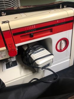 Sewing machine with carrier bag and sewing kit