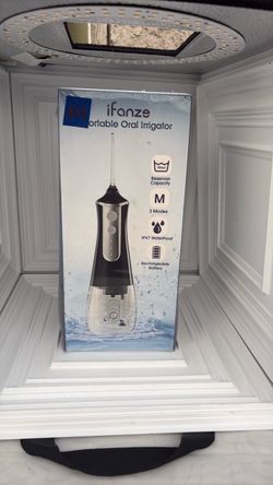 Portable oral irrigator