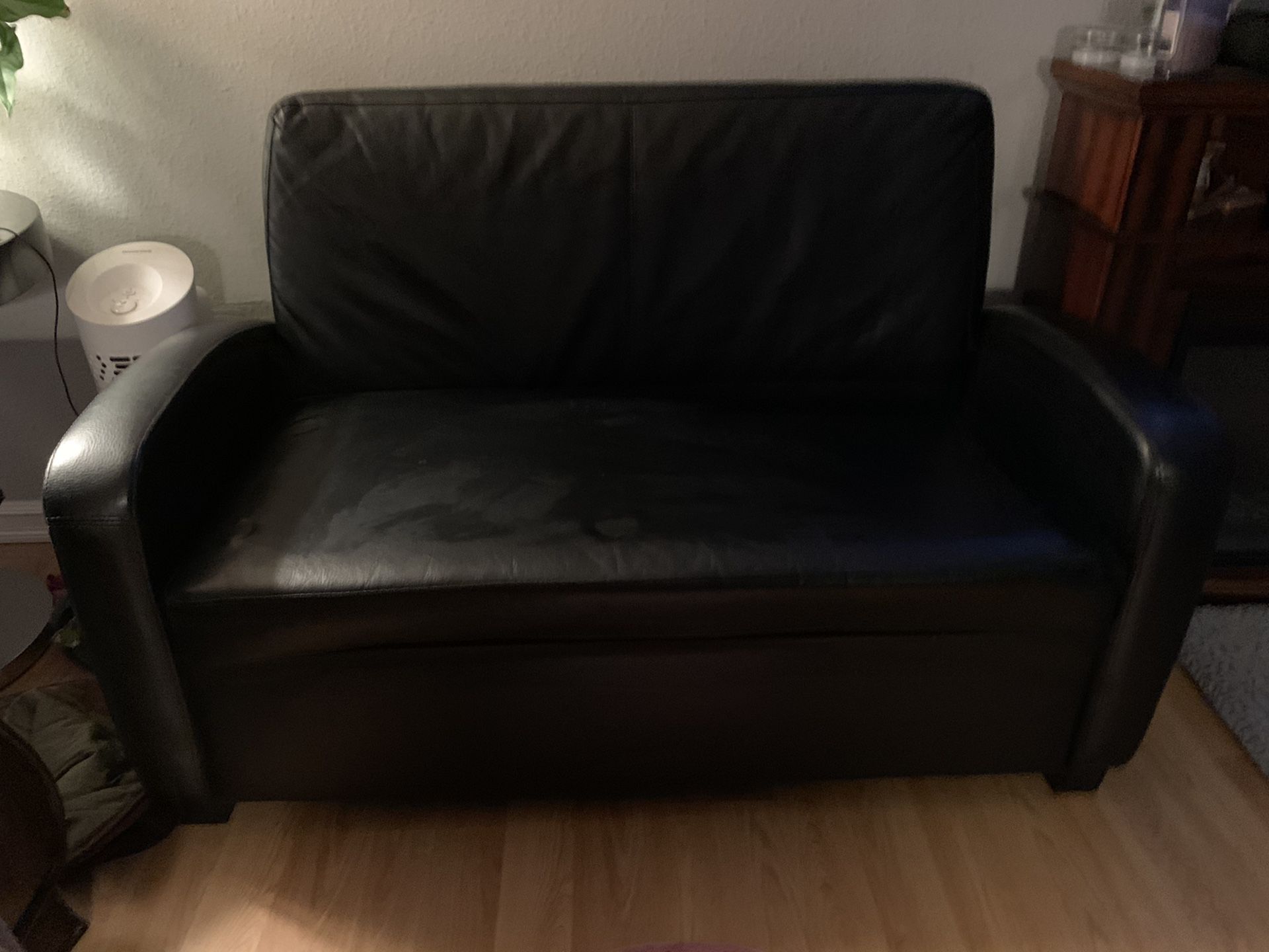Black love seat hide a bed