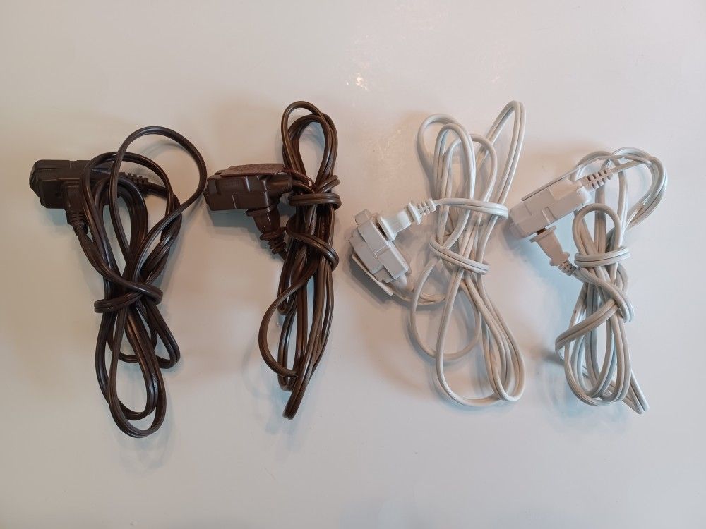 Four indoor 6 foot extension cords 2 prong with 3 outlet Ends
