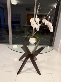 Round glass dining table with wood legs