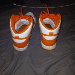 The Or And White Nike  Shoe  And Playstation 4 Is On Sale 