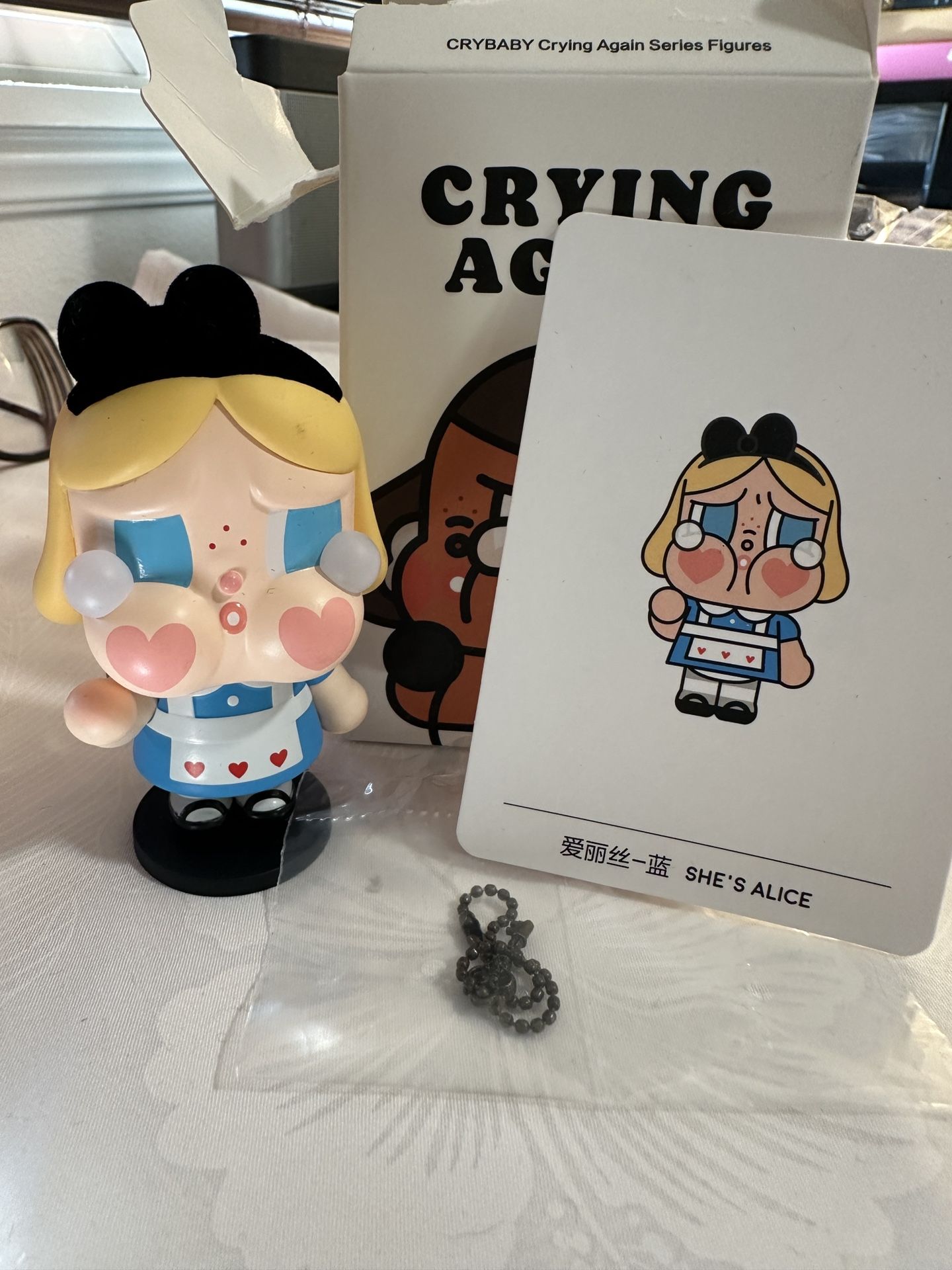 The Pop MART Crybaby Crying Again Series Figurines Love is Love is a 5-inch PVC action figure featuring the character Crybaby from the TV show "Crybab