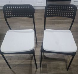 Two chairs with cushions and table