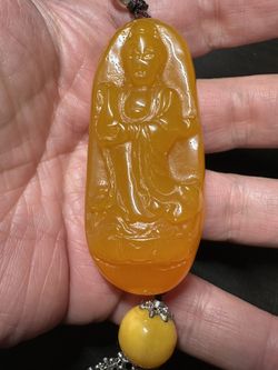 Guanyin Bodhisattva pendant, carved from yellow amber has a warm honey-yellow color