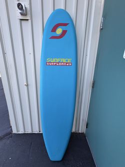 MINT CONDITION !!! This is a blue Surface Surfboards soft-top surfboard, which is designed to be a durable and accessible surfboard suitable for vario