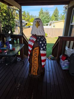 American flag wrappedbal eagle wood carving