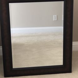 Dark wood framed beveled mirror