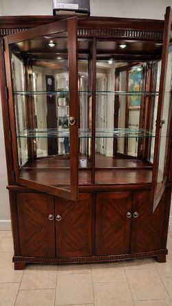 China cabinet with glass display and storage base.”