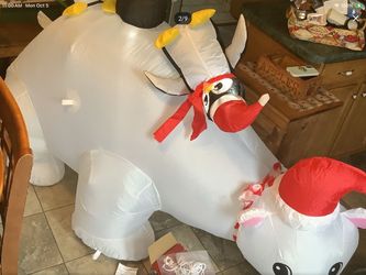 Gemmy 6.5 foot inflatable Penguins sitting on Polar bear, used indoors at school fair. Like new condition Comes with tie down ropes and extra bags No