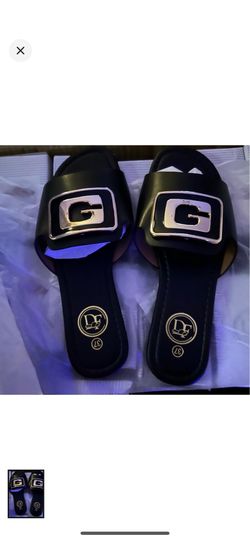 DF black slide mules with a bold silver buckle