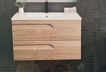 Floating single bathroom vanity with porcelain sink.