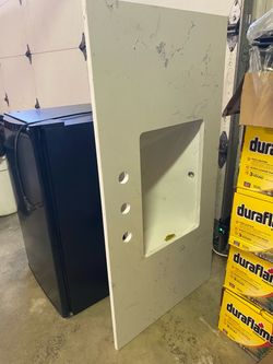 White quartz bathroom countertop with sink