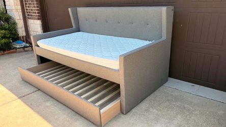 Stylish gray daybed with pull-out trundle. Includes mattress.