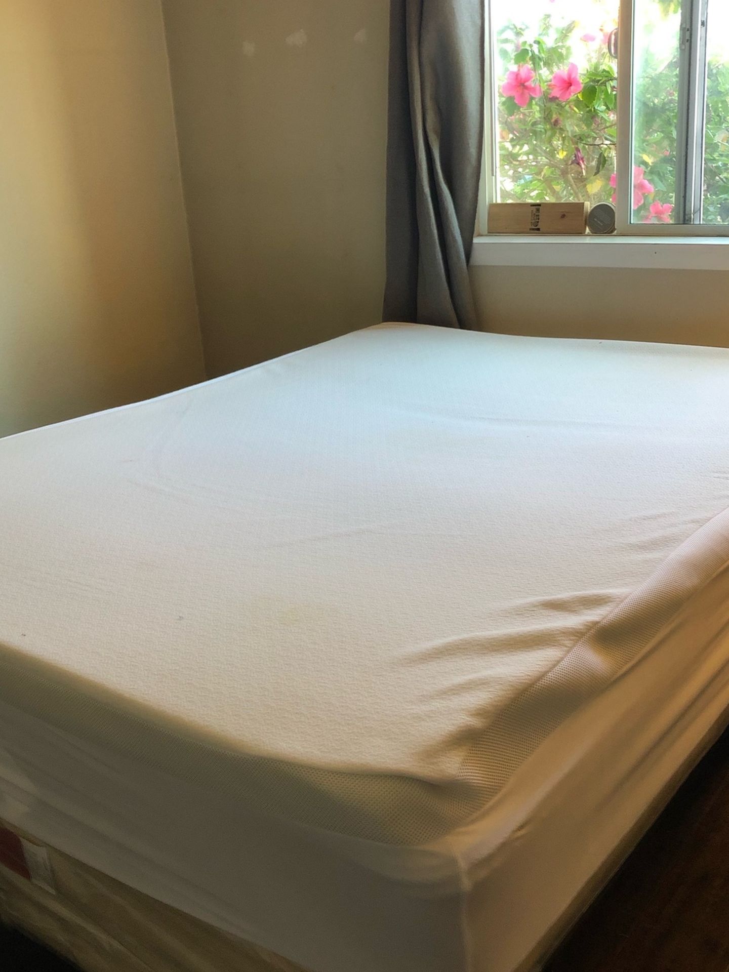 Lightly used queen sized mattress on full bed frame.