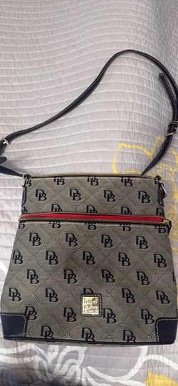 Dooney & Bourke Signature DB Monogram jacquard canvas crossbody bag featuring a front zip pocket and gold-tone metal logo plate