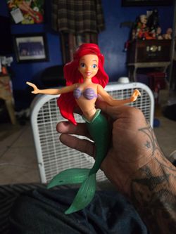 vintage Disney On Ice Princess Ariel posable plastic figure. It stands about 7 to 8 inches tall and features her iconic look from The Little Mermaid.