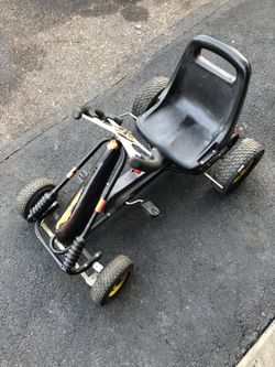 Pedal go cart with hand pull brakes and bucket seat. Good to get In shape