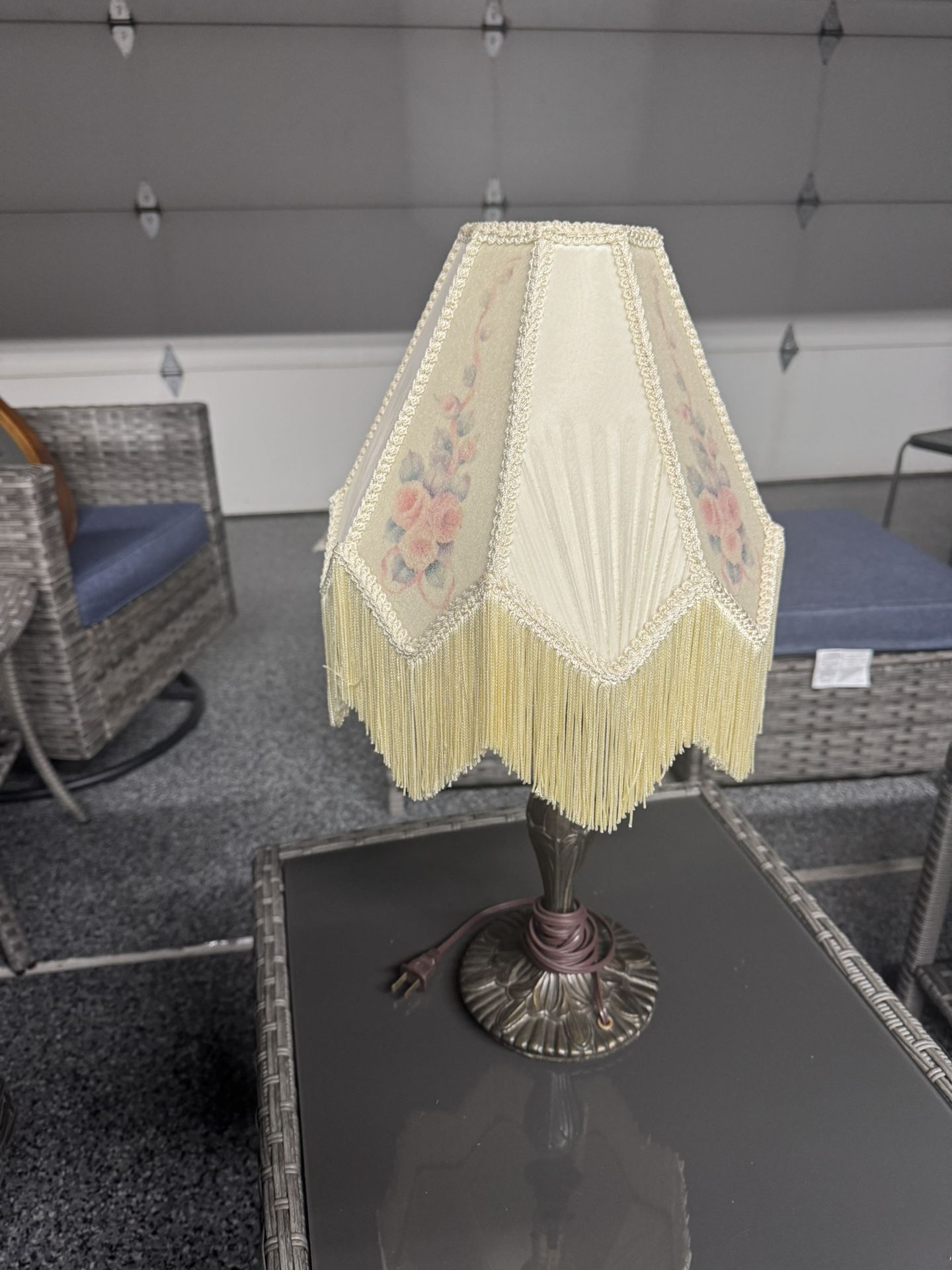 Victorian-style table lamp with fringe shade.