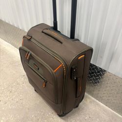 Travellite brand cloth carry-on luggage on four wheels. 20”  x 15”. $40