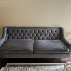 large tufted grey sofa