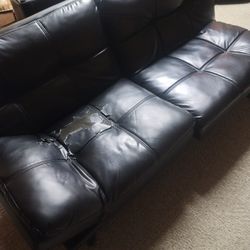 2 Matching Faux Leather Black Futons. Some Wear Comes With Matching Ottomans &Slip Covers.