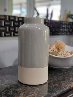 Cylindrical ceramic vase. Magnolia Joanna Gaines Home Decor Farmhouse style. Made in Vietnam; features a glazed gray finish on the upper section and a