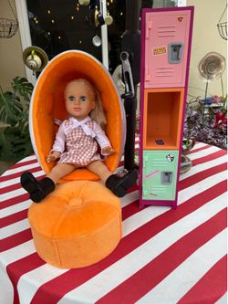 American girl doll with egg chair/ottoman and locker.
