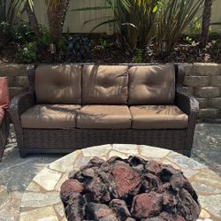 Three-piece wicker set with one sofa and two swivel chairs
