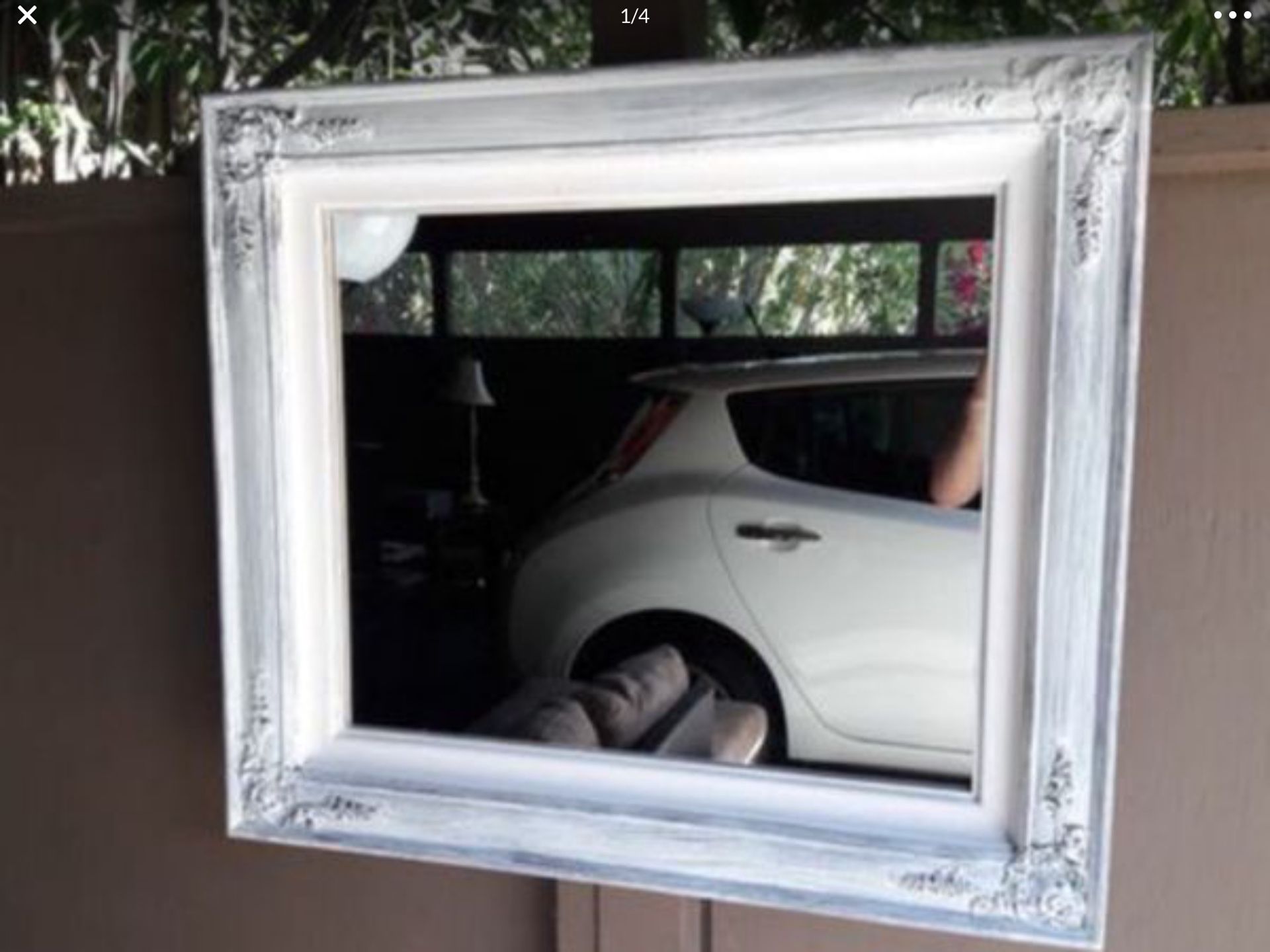 A Antique Mirror with white trim , 32 inches wide and 28 inches high for $30