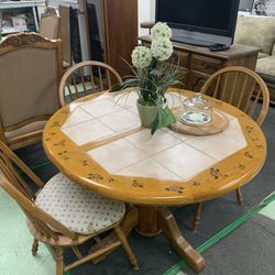 Circular Wooden Table With Design And Three Chairs
