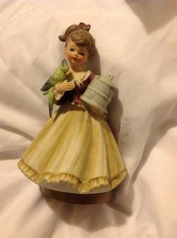 Little girl holding bird music box