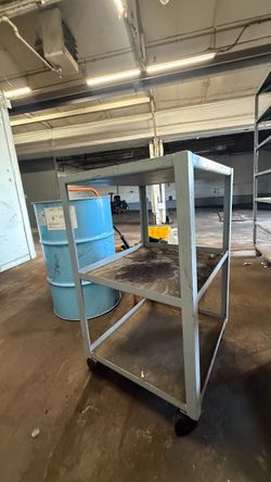 Wheeled steel fabricated working bench. 3ft tall, 28” im length by 24” in width.