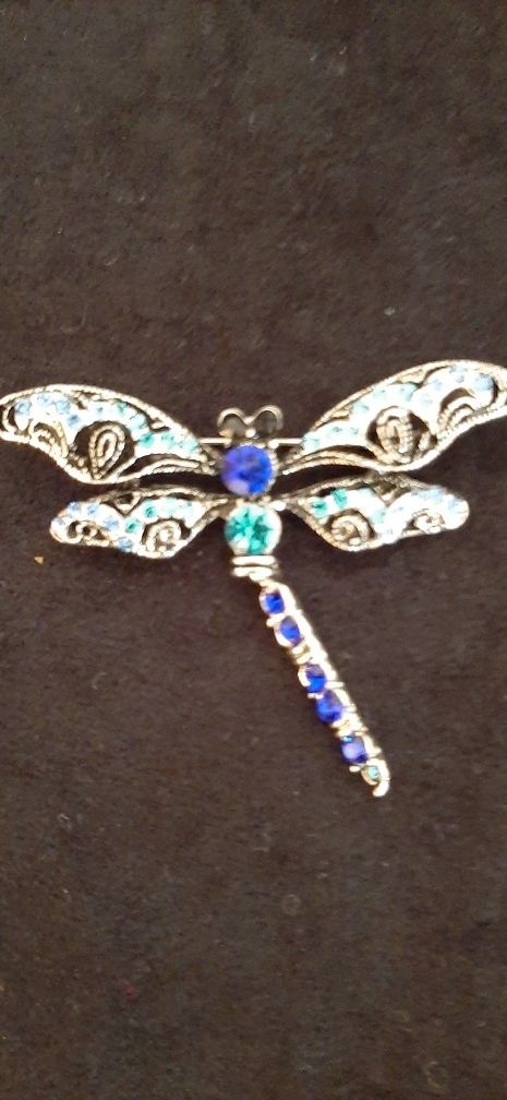 Silver tone dragonfly brooch.