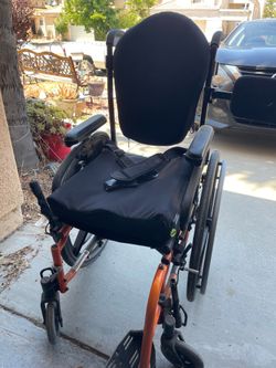 One arm drive foldable wheelchair with removable arm rests one foot rest adjustable back a removable trunk support and a seat cushion