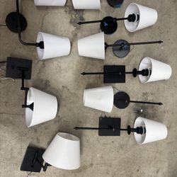 Modern black metal chandelier with a clean, minimalist design. Features six arms with exposed bulbs for a contemporary or industrial look. Perfect for