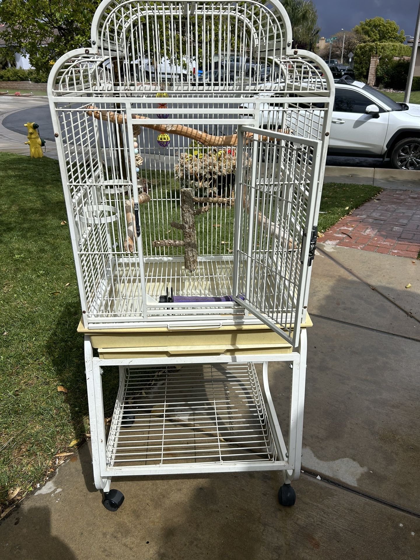 Large bird cage on rolling cart