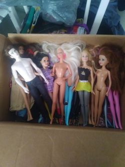 Box of Barbies 13 of them with clothes and Bootsand 1 man