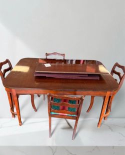 Vintage 1950s mahogany dining table with 4 chairs.