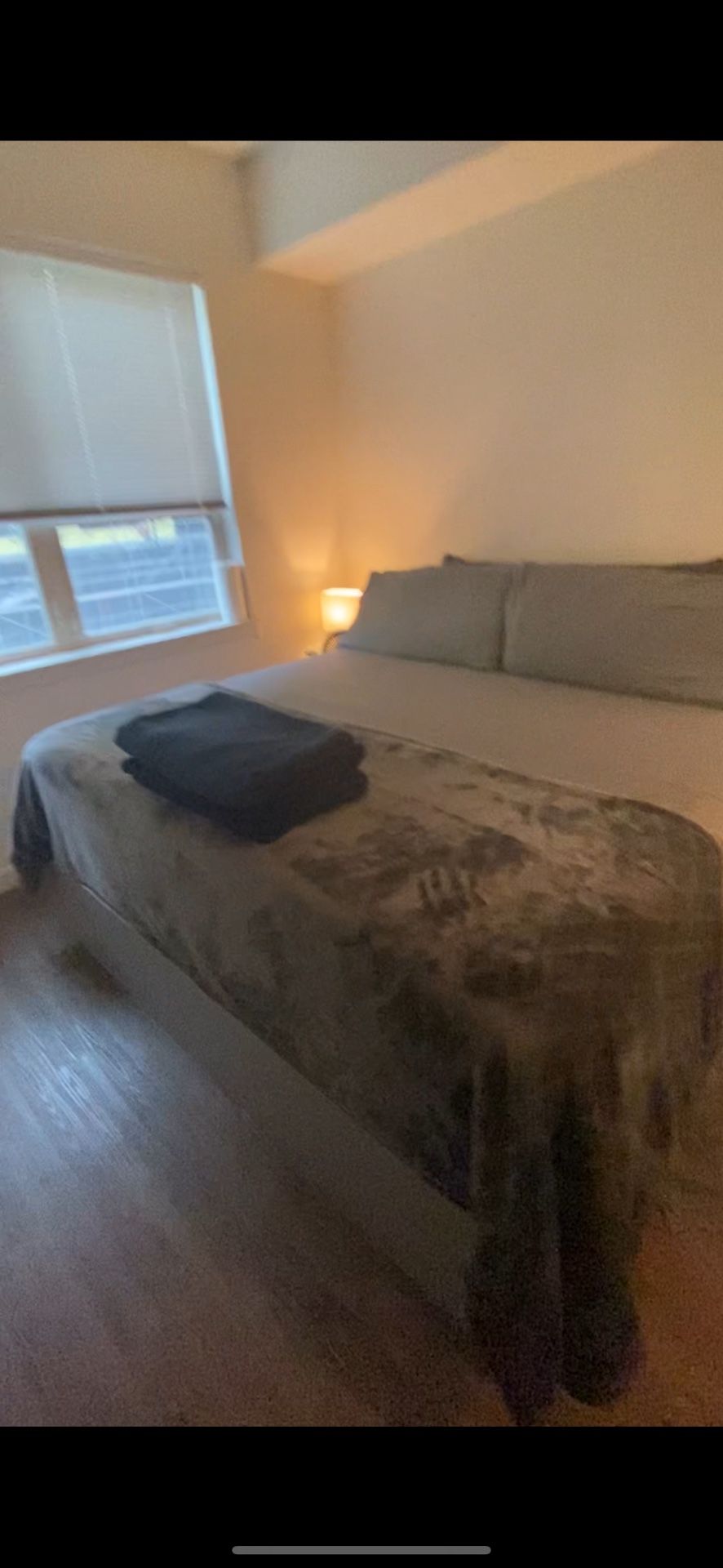 King Size Bed With Pillows And Side tables And Lamps