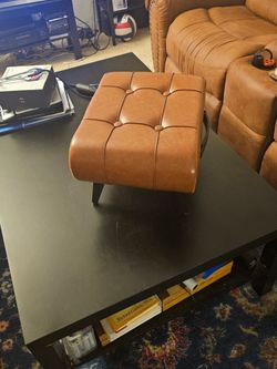 BROWN NEW BROWN LEATHER STOOL. VERY STURDY AND GREAT FOR YOUR FEET COMFORT
