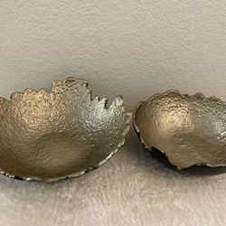 Set of two textured gold bowls with unique edges.