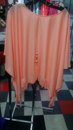 Peach poncho with long necklace