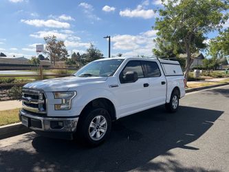 Ford F-150 Crew Cab Pickup Truck with Camper Shell