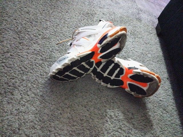 Balenciaga Track sneakers in white and orange leather and mesh. 
