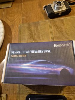 Dohonest vehicle rear view camera system