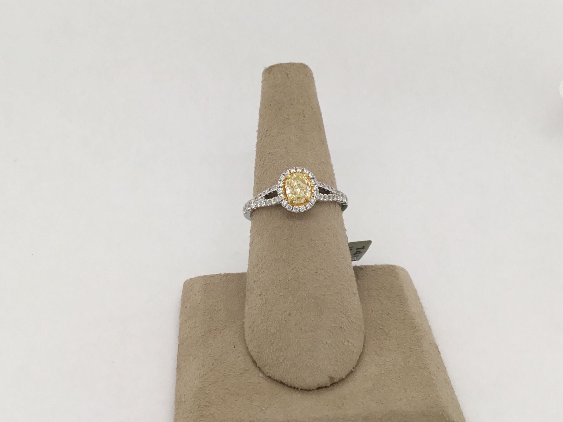 18 karat white gold oval cut, Fancy yellow diamond halo ring with split shank