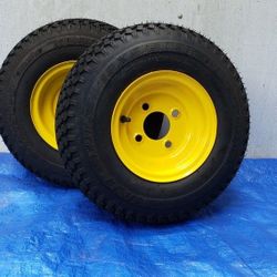 Pair of 18x6.50-8 Kenda Superturf tires on a 4-lug JD yellow wheel